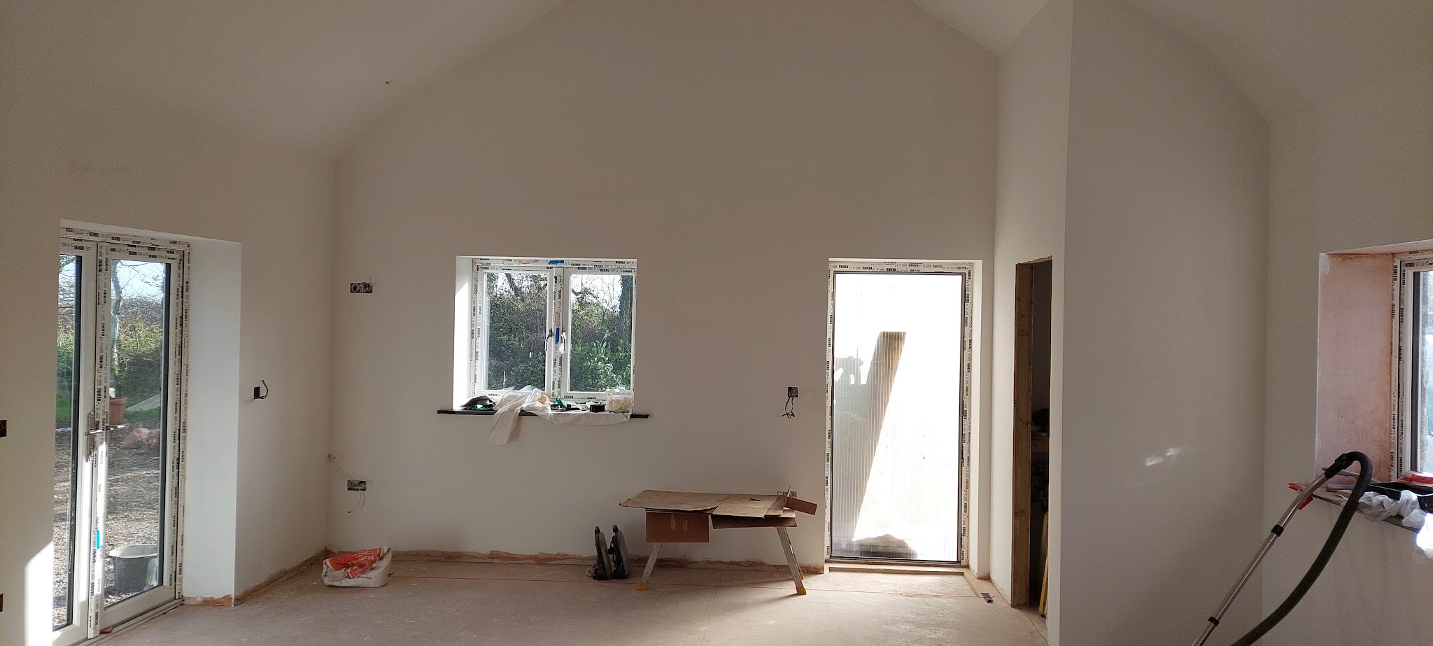 Wide view of a large vaulted room with smooth finished walls